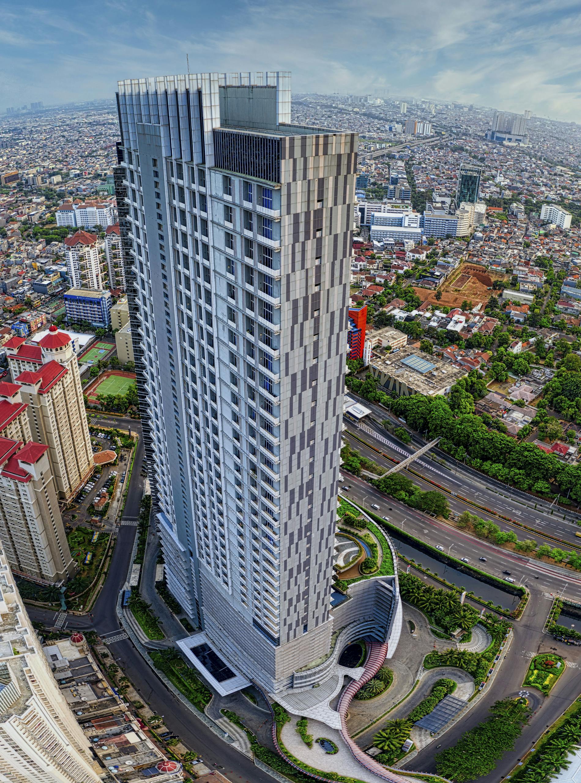 A breathtaking aerial shot of a modern skyscraper in Jakarta, offering a panoramic cityscape view.